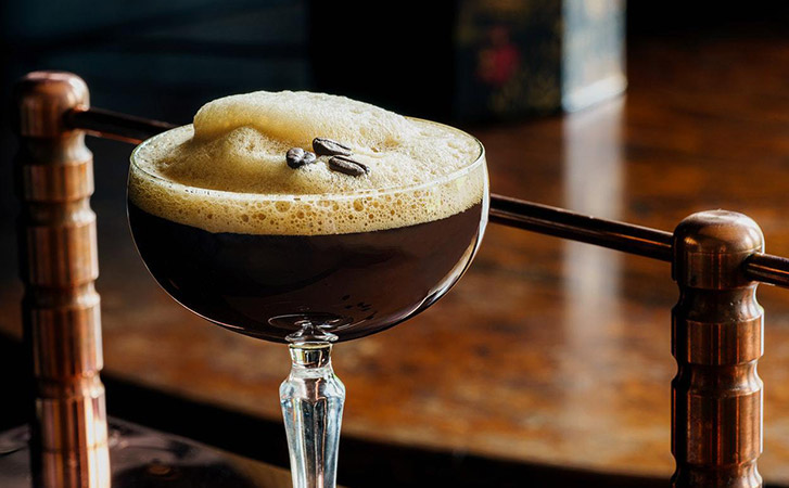 An espresso martini in a crystal glass